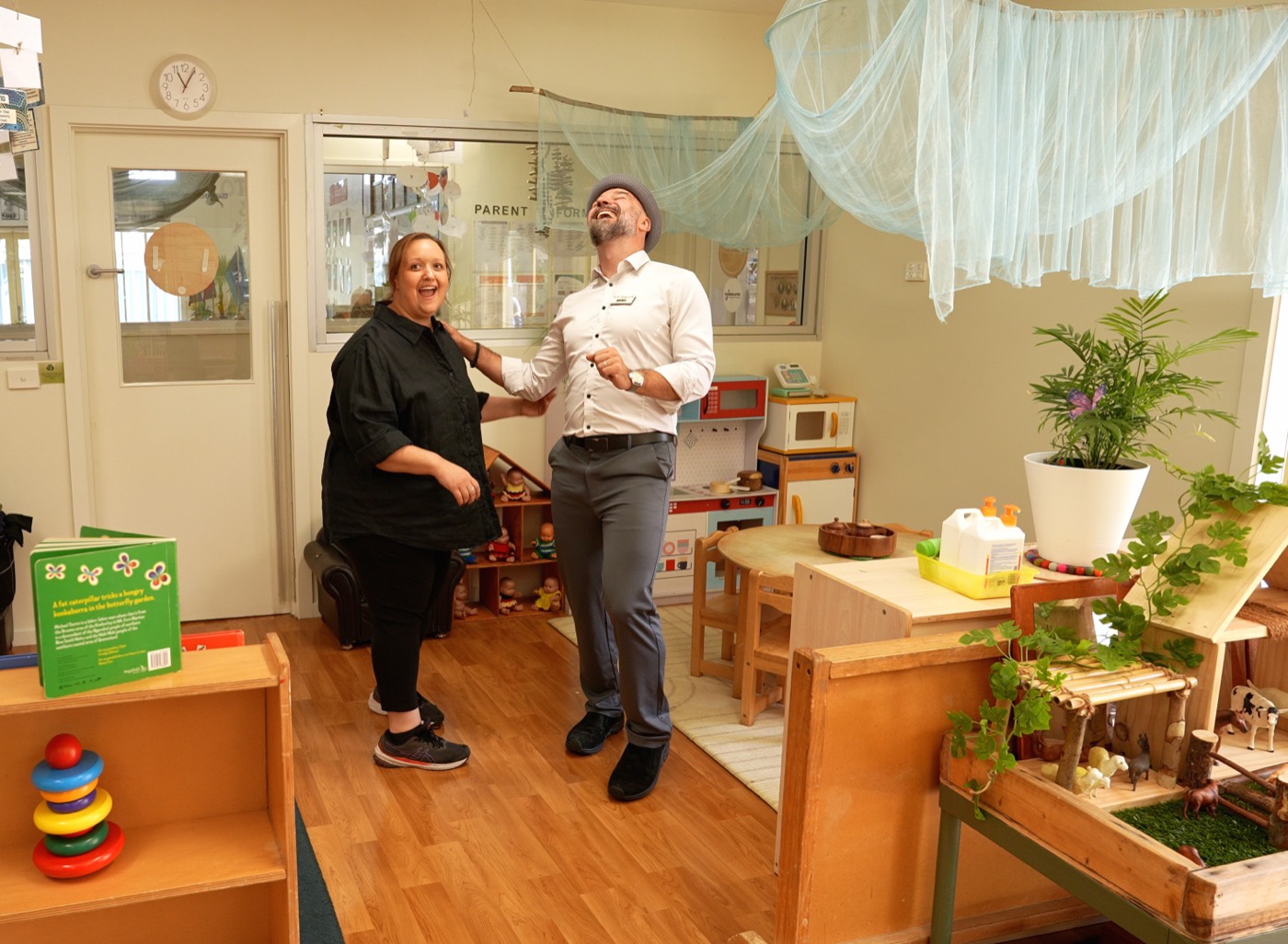 Arek from EEVA sharing a laugh with an educator in a centre playroom during a shoot