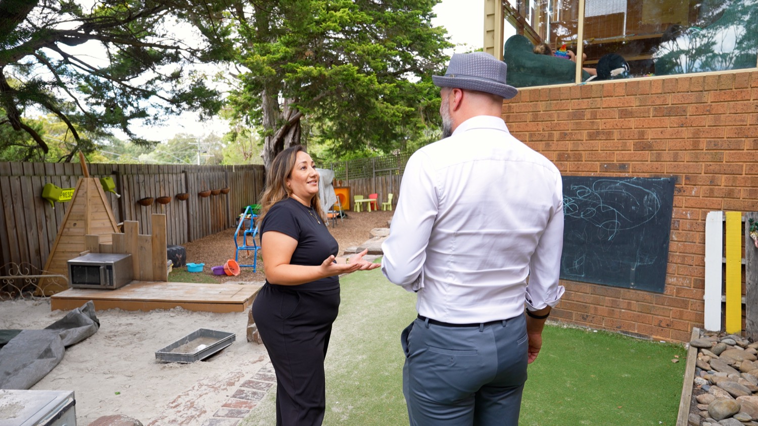 EEVA founder Arek Rainczuk walking a Melbourne centre's outdoor space with a director