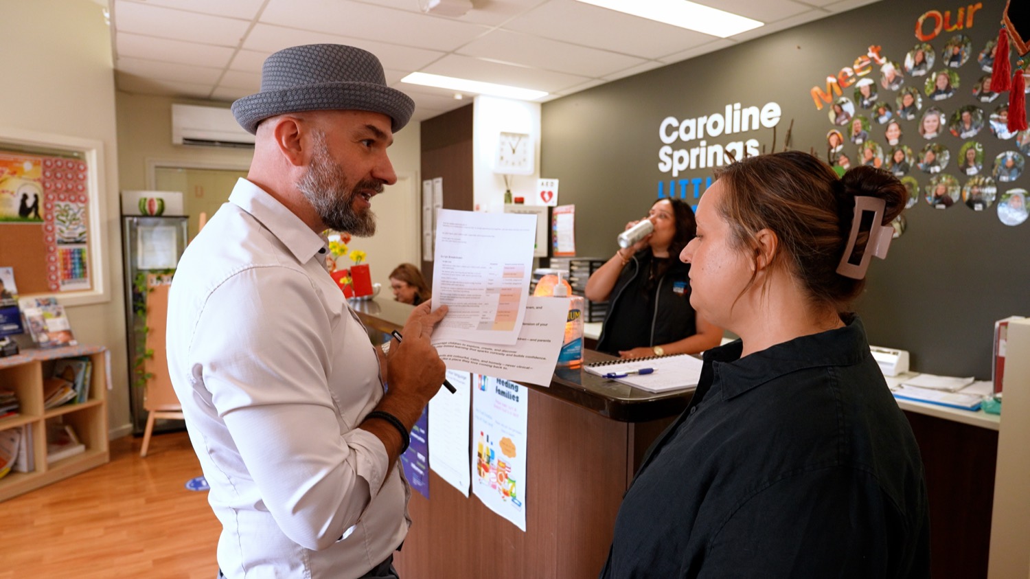 Arek Rainczuk in conversation with centre staff at reception