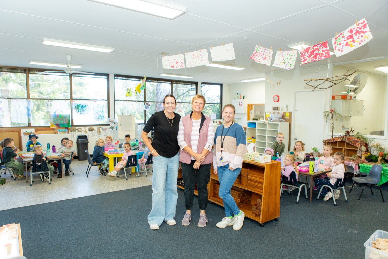 Educators and a director in an early learning room