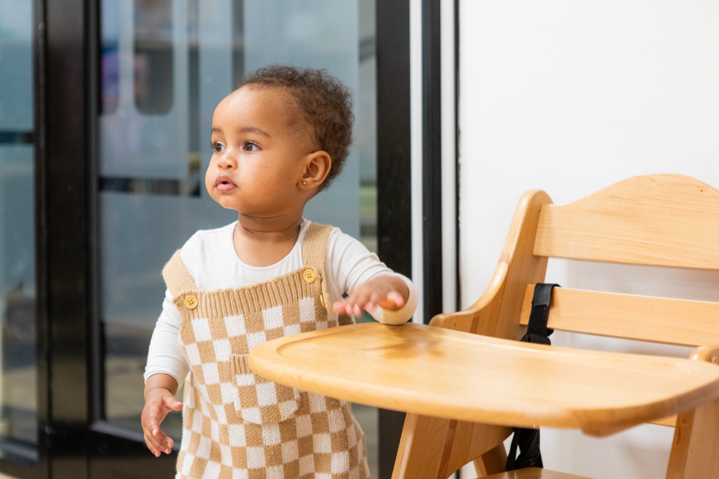 A toddler at a high chair, photographed at an early learning centre