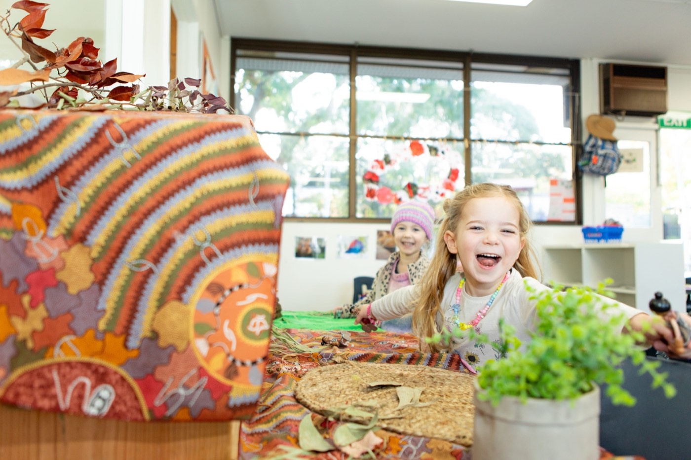 A child mid-laugh at an early learning centre