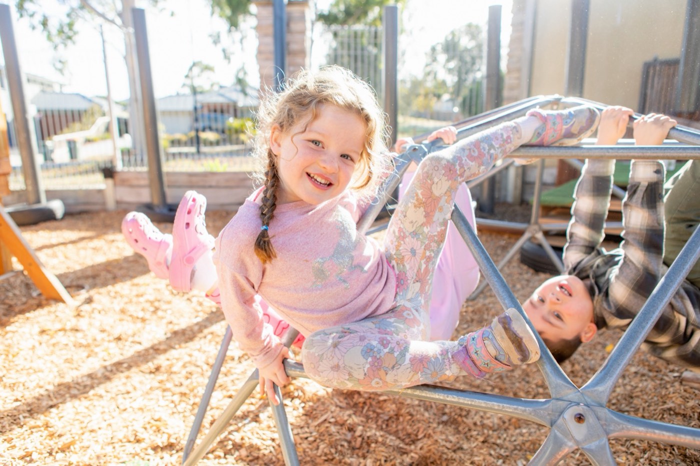 A child playing happily in a centre's outdoor space