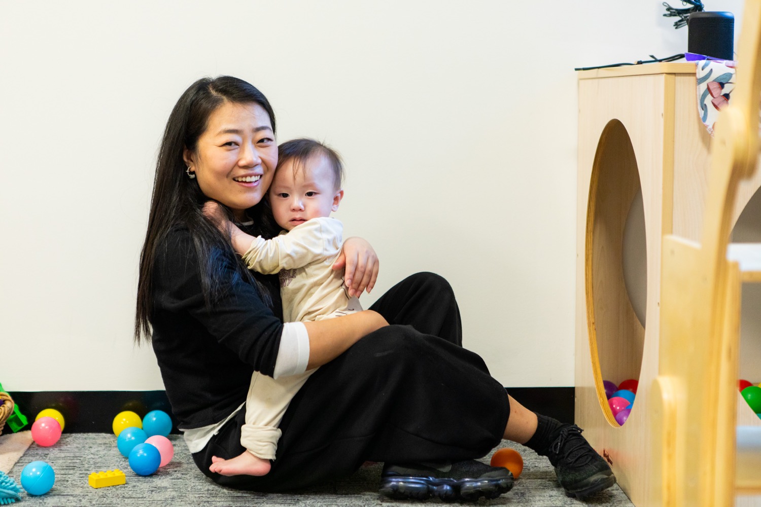 An educator holding a young child